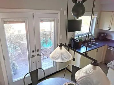two lights in a kitchen with a table and chairs at LakePark Artsy 3 bedroom Townhouse 1 Parking in Toronto