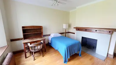 a bedroom with a bed and a fireplace at Knox Residence - University of Toronto in Toronto