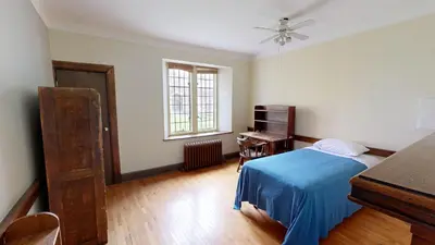 a bedroom with a bed and a desk and a piano at Knox Residence - University of Toronto in Toronto