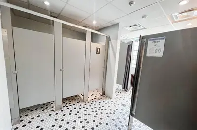 a row of stalls in a hospital hallway with doors at Knox Residence - University of Toronto in Toronto