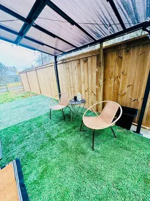 two chairs and a table on a patio at Cozy private backyard garden studio in Pickering