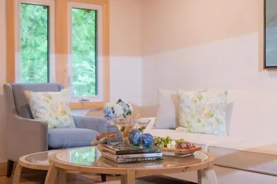 a living room with a coffee table and a couch at Haliburton Post House in Minden