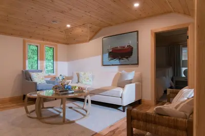 a living room with a couch and a table at Haliburton Post House in Minden