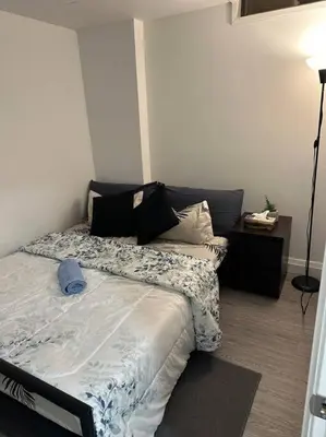 a bedroom with a bed with pillows on it at One-Bedroom Basement in Oshawa