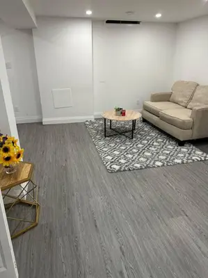 a living room with a couch and a coffee table at One-Bedroom Basement in Oshawa