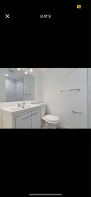 a white bathroom with a sink and a toilet at One-Bedroom Basement in Oshawa