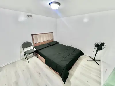 a bedroom with a bed and a chair in it at Private Room Near Airport D7 in Brampton