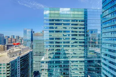 a view of a large glass building in a city at The Urban Escape in Toronto