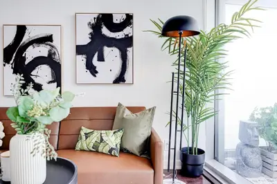 a living room with a couch and some plants at The Urban Escape in Toronto