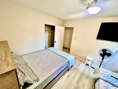 a room with two beds and a flat screen tv at Private Room Near Airport D2 in Brampton