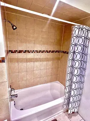a bathroom with a bath tub with a shower at Private Room Near Airport D4 in Brampton