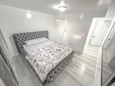 a bedroom with a bed in a room with a door at Private Room Near Airport D5 in Brampton