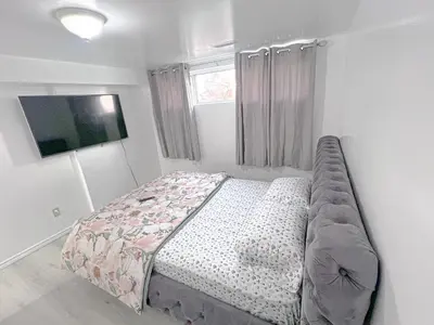 a bedroom with a bed and a television in it at Private Room Near Airport D5 in Brampton