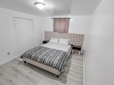 a small bedroom with a bed and a window at Private Room Near Airport D8 in Brampton