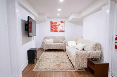 a living room with a couch and two chairs at Adorable 3 Bedroom Apartment with Free Parking in Ajax