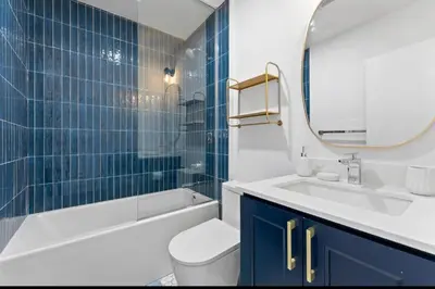 a bathroom with a sink toilet and a mirror at Chic 2BR Top Floor Retreat with Rooftop Near Subway in Toronto