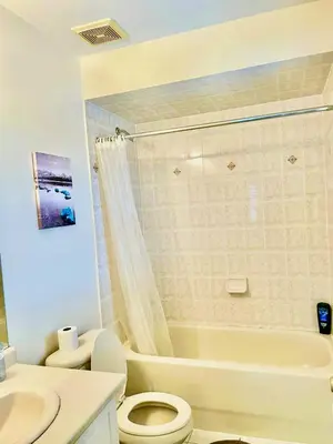 a bathroom with a toilet and a tub and a sink at Extended Stays Home in Markham