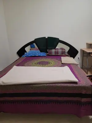 a bed with a blanket and pillows on it at Extended Stays Home in Markham