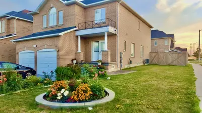 a house with a flower garden in front of it at Extended Stays Home in Markham