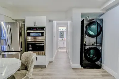 a kitchen with stainless steel appliances and a table at Luxurious Unit in Hyde Park in London
