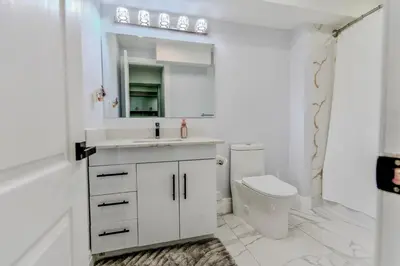a white bathroom with a sink and a toilet at Luxurious Unit in Hyde Park in London
