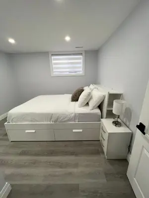 a white bedroom with a bed and a window at Luxurious Unit in Hyde Park in London