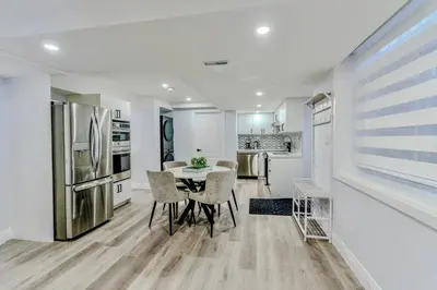 a kitchen and dining room with a table and a refrigerator at Luxurious Unit in Hyde Park in London