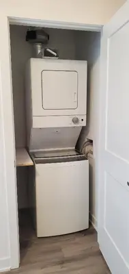 a kitchen with a computer on top of a refrigerator at 1 Bedroom condo with balcony Erb St Waterloo in Waterloo