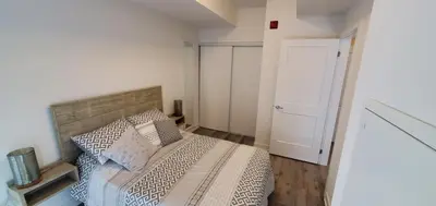 a small bedroom with a bed and a door at 1 Bedroom condo with balcony Erb St Waterloo in Waterloo
