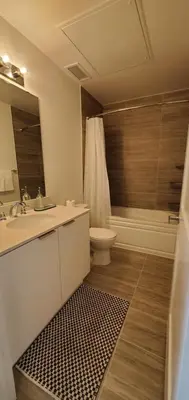 a bathroom with a sink and a toilet and a tub at 1 Bedroom condo with balcony Erb St Waterloo in Waterloo