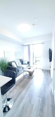 a living room with a couch and a table at 1 Bedroom condo with balcony Erb St Waterloo in Waterloo
