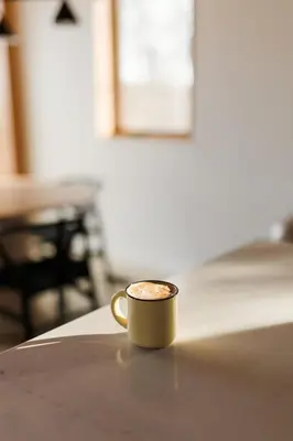 a cup of coffee sitting on a table at Camp Haliburton - Waterfront A-Frame in Wilberforce