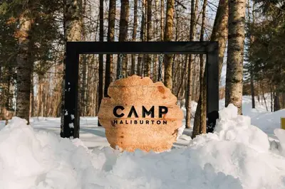 a sign in the snow in front of a forest at Camp Haliburton - Waterfront A-Frame in Wilberforce