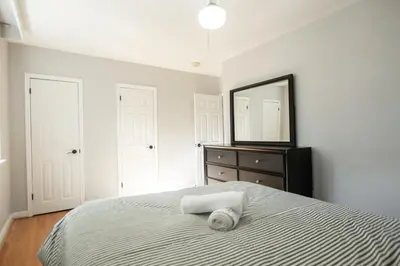 a bedroom with a bed with a mirror and a dresser at Charming 4BR Barrie Retreat with Backyard in Barrie
