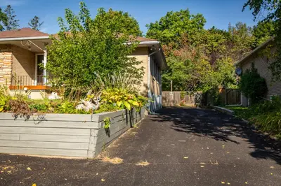 a house with a planter of bananas in a driveway at Charming 4BR Barrie Retreat with Backyard in Barrie