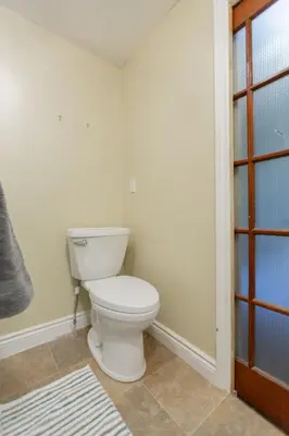 a bathroom with a white toilet in a room at Barrie Bliss 3BR Haven near Centennial Beach in Barrie