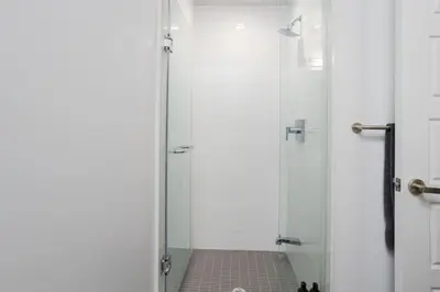 a bathroom with a shower with a glass door at Amazing 2BR 2BA Resort Condo w Balcony and Parking in Barrie