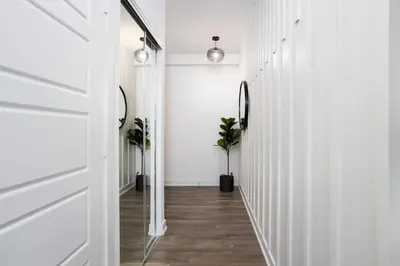 a hallway with white walls and a door at Amazing 2BR 2BA Resort Condo w Balcony and Parking in Barrie