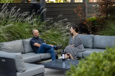 a man and a woman sitting on a couch at The VanderMarck Boutique Hotel in Collingwood