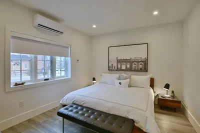 a bedroom with a large bed and a window at The VanderMarck Boutique Hotel in Collingwood