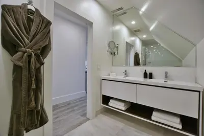a bathroom with a sink and a mirror at The VanderMarck Boutique Hotel in Collingwood