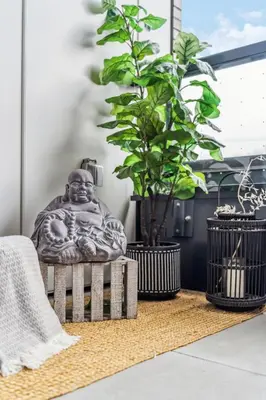 a statue sitting on a rug next to two plants at Designer Yonge & Eglinton Gem, Parking, 65 TV in Toronto
