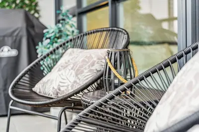 a couple of chairs sitting on a porch with a pillow at Designer Yonge & Eglinton Gem, Parking, 65 TV in Toronto