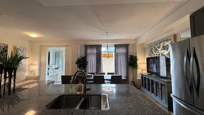a kitchen and living room with a sink and a refrigerator at 9 Queen Beds, 18 Guests-Kleinburg Luxe Crown Town Residence in Vaughan