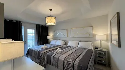 a bedroom with a bed and a chandelier at 9 Queen Beds, 18 Guests-Kleinburg Luxe Crown Town Residence in Vaughan