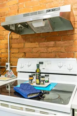 a kitchen counter with a stove top oven at Boutique 2BR Apartment on James St North Sleeps 6 in Hamilton