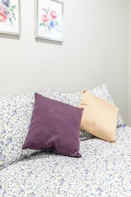 two pillows sitting on a bed in a bedroom at Boutique 2BR Apartment on James St North Sleeps 6 in Hamilton