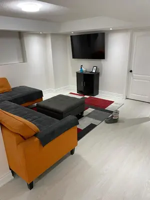 a living room with a couch and a flat screen tv at Akhtar's Residence in Mississauga