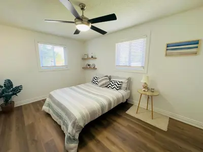 a bedroom with a bed and a ceiling fan at Lovely Beachside Oasis 2BD in Port Dover in Port Dover