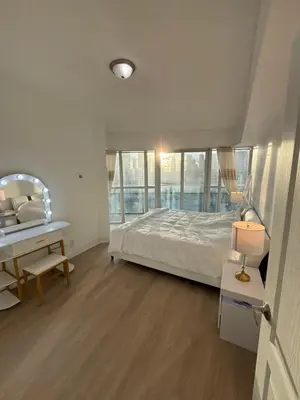 a bedroom with a bed and a desk and a table at 2 Bedroom 1 Bathroom renovated fully furnished apartment in Mississauga